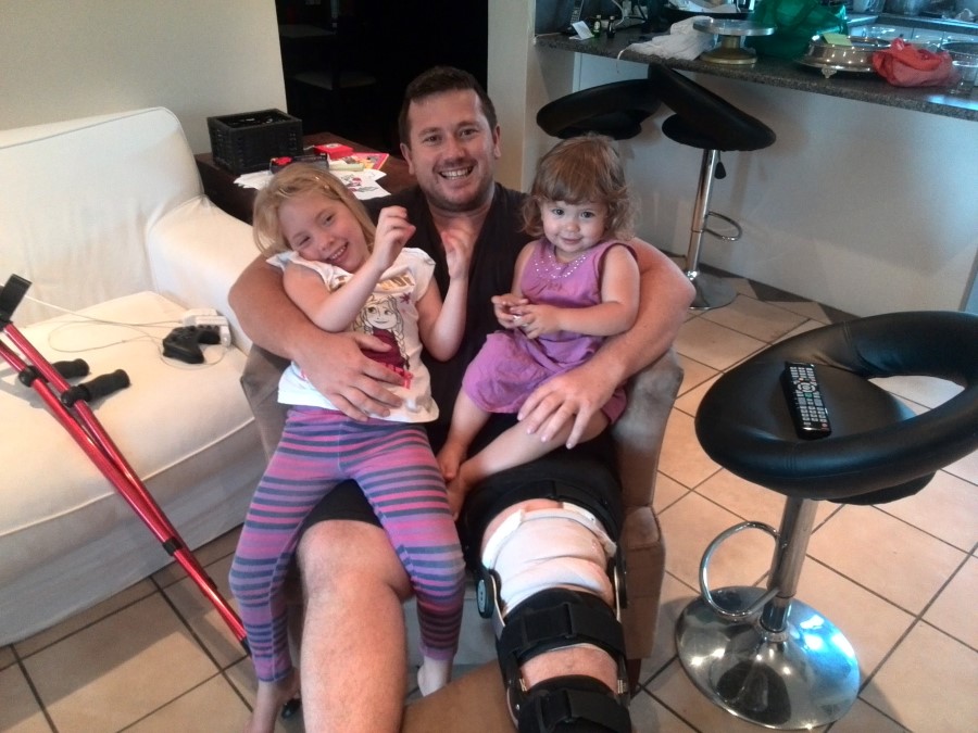IMG_20151214_191909 craig lotter in a leg brace holding jessica and emily on his lap